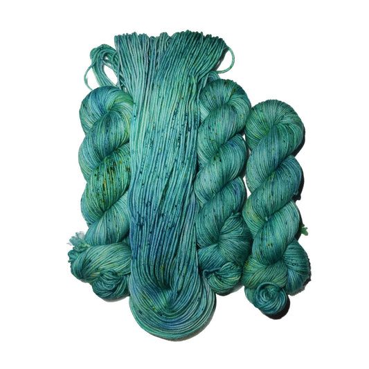Turquoise skeins of yarn on a white background
